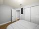 Bedroom featuring wood floors, double door closet, and door to the rest of the house at 4816 N Highland Ave, Tampa, FL 33603