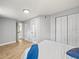Bedroom with gray walls, hardwood floors, closet, and bathroom access via the doorway at 4816 N Highland Ave, Tampa, FL 33603