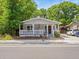 Inviting single-story home with a classic front porch and well-maintained landscaping at 4816 N Highland Ave, Tampa, FL 33603