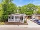 Charming single-story home with a covered front porch, landscaped yard, and a concrete driveway at 4816 N Highland Ave, Tampa, FL 33603