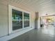 Covered front porch with a large window, white railings, and gray flooring at 4816 N Highland Ave, Tampa, FL 33603