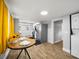 Bright kitchen with stainless steel appliances, wood floors, breakfast table, and yellow curtains at 4816 N Highland Ave, Tampa, FL 33603