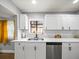 Updated kitchen with stainless steel appliances, white cabinets, and bright natural light at 4816 N Highland Ave, Tampa, FL 33603