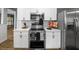 Updated kitchen with stainless steel appliances, white cabinets, subway tile backsplash, and wood-look flooring at 4816 N Highland Ave, Tampa, FL 33603