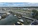 Aerial view of a waterfront community featuring a boat marina, parking, and scenic surroundings at 4939 Floramar Ter # 810, New Port Richey, FL 34652