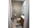 Bathroom featuring tile flooring, wood vanity, and blue accent walls at 4939 Floramar Ter # 810, New Port Richey, FL 34652