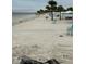 Beautiful beach with white sand and blue lounge chairs, perfect for relaxing and enjoying the serene coastal atmosphere at 4939 Floramar Ter # 810, New Port Richey, FL 34652