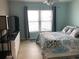 Bright bedroom with large window and neutral toned tile flooring at 4939 Floramar Ter # 810, New Port Richey, FL 34652
