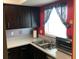 Kitchen featuring quartz countertops and dark wood cabinetry at 4939 Floramar Ter # 810, New Port Richey, FL 34652