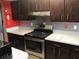 Modern kitchen with stainless steel appliances, quartz counters, and sleek cabinetry at 4939 Floramar Ter # 810, New Port Richey, FL 34652