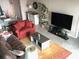 A comfortable living room with cozy seating, tile floors, and lots of natural light at 4939 Floramar Ter # 810, New Port Richey, FL 34652