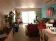 Open living area with ceiling fan, tile floors, and sliding glass doors at 4939 Floramar Ter # 810, New Port Richey, FL 34652