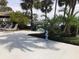 A tranquil outdoor space with lounge chairs, palm trees, and a seaside statue at 4939 Floramar Ter # 810, New Port Richey, FL 34652