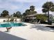 A refreshing community pool with a shaded cabana and comfortable lounge chairs at 4939 Floramar Ter # 810, New Port Richey, FL 34652