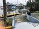 Scenic waterfront with docks, boats, and blue building accessible via concrete steps with cautionary signage at 4939 Floramar Ter # 810, New Port Richey, FL 34652