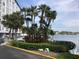 Scenic waterfront view featuring palm trees and lush landscaping along the water's edge at 4939 Floramar Ter # 810, New Port Richey, FL 34652