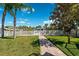 Lush backyard with a white fence and palm trees, perfect for outdoor activities at 5500 Leahy Ln, New Port Richey, FL 34652