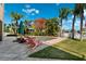 Landscaped backyard featuring a refreshing pool surrounded by lush greenery and a comfortable seating area at 5500 Leahy Ln, New Port Richey, FL 34652