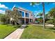 Landscaped backyard with a pool, patio, and manicured lawn for relaxation at 5500 Leahy Ln, New Port Richey, FL 34652