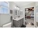 Bright bathroom with a modern vanity, ample storage in the closet, and updated fixtures for a clean aesthetic at 5500 Leahy Ln, New Port Richey, FL 34652