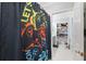 Bathroom features a colorful shower curtain and open shelving for convenient storage in an efficient space at 5500 Leahy Ln, New Port Richey, FL 34652