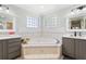Bright bathroom features a jacuzzi, tile surround and modern fixtures at 5500 Leahy Ln, New Port Richey, FL 34652