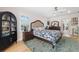 Bedroom with a floral bedspread, shutters, a ceiling fan, and hardwood flooring at 5500 Leahy Ln, New Port Richey, FL 34652