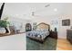 Comfortable bedroom with shuttered windows, ceiling fan and an area rug on the hardwood floor at 5500 Leahy Ln, New Port Richey, FL 34652