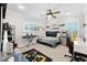 Well-lit bedroom featuring a ceiling fan, a comfortable bed, and windows that bring in natural light at 5500 Leahy Ln, New Port Richey, FL 34652