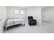 Bright room featuring a bed, a cozy chair, and neutral tones at 5500 Leahy Ln, New Port Richey, FL 34652