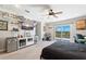 Well-lit bedroom with a ceiling fan, TV and sliding doors to the balcony at 5500 Leahy Ln, New Port Richey, FL 34652