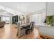 Open dining room space with hardwood floors, a chandelier, and a bookshelf at 5500 Leahy Ln, New Port Richey, FL 34652