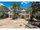Two-story coastal home with a spacious driveway and palm trees in a waterfront community at 5500 Leahy Ln, New Port Richey, FL 34652