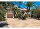Stunning two-story home with lush landscaping, a circular driveway, and a grand entrance at 5500 Leahy Ln, New Port Richey, FL 34652