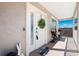 Inviting front door adorned with wreath, with a cozy bench on a covered porch at 5500 Leahy Ln, New Port Richey, FL 34652