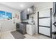 Functional laundry room with modern appliances, ample counter space, and cabinet space for efficient organization at 5500 Leahy Ln, New Port Richey, FL 34652