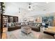 Open concept living room with hardwood floors, shelving and a large sectional at 5500 Leahy Ln, New Port Richey, FL 34652