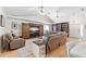 Cozy living room featuring a large screen TV, bookshelves, and comfortable seating at 5500 Leahy Ln, New Port Richey, FL 34652