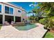 Inviting pool area with lush tropical landscaping, lounge chairs, and privacy fence at 5500 Leahy Ln, New Port Richey, FL 34652