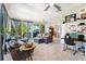 Relaxing sunroom featuring comfortable seating, a ceiling fan, and a dedicated work space at 5500 Leahy Ln, New Port Richey, FL 34652