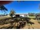Rear exterior view showing a screened in patio and a large yard at 6012 Landover Blvd, Spring Hill, FL 34609