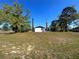 Spacious backyard with mature trees offering privacy and shade for the home at 6012 Landover Blvd, Spring Hill, FL 34609