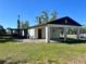 Backyard view showcasing a covered carport and screened-in patio, ideal for outdoor living at 6012 Landover Blvd, Spring Hill, FL 34609