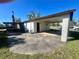 Wide backyard featuring a covered carport and screened-in porch, enhancing outdoor comfort at 6012 Landover Blvd, Spring Hill, FL 34609
