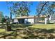 A spacious backyard featuring a well and partially covered patio area, providing relaxation space at 6012 Landover Blvd, Spring Hill, FL 34609