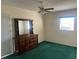Comfortable bedroom featuring a dresser, green carpet and lots of light at 6012 Landover Blvd, Spring Hill, FL 34609