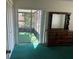 Bedroom with a dresser, closet and sliding glass door leading to the screened-in patio at 6012 Landover Blvd, Spring Hill, FL 34609