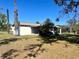 Rear view showing a screened in porch and established foliage at 6012 Landover Blvd, Spring Hill, FL 34609