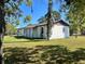 Side view of a well-kept one story home with a lush green lawn at 6012 Landover Blvd, Spring Hill, FL 34609