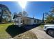 Charming home with a convenient carport, situated on a well-manicured lawn at 6012 Landover Blvd, Spring Hill, FL 34609